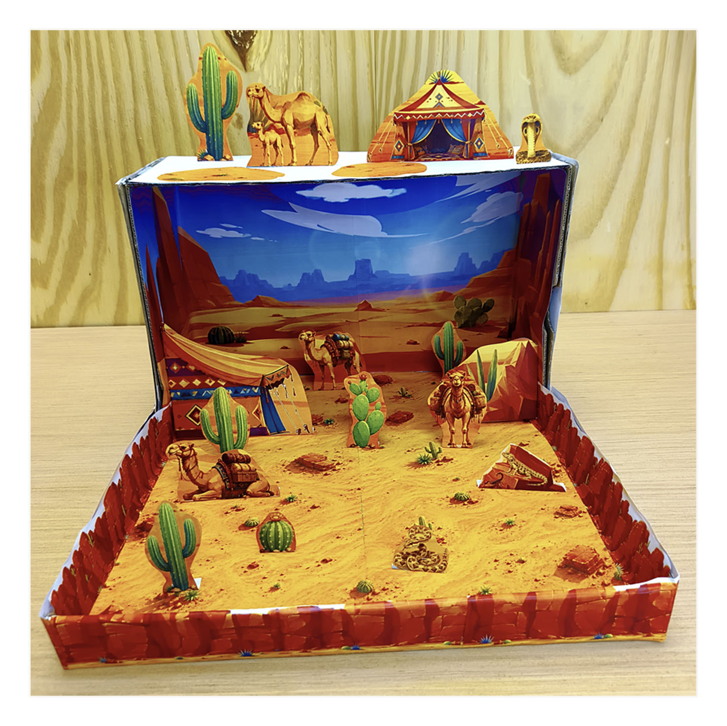Completed printable Desert Habitat shoebox diorama for kids with camels, desert scenery, tents and sand dunes
