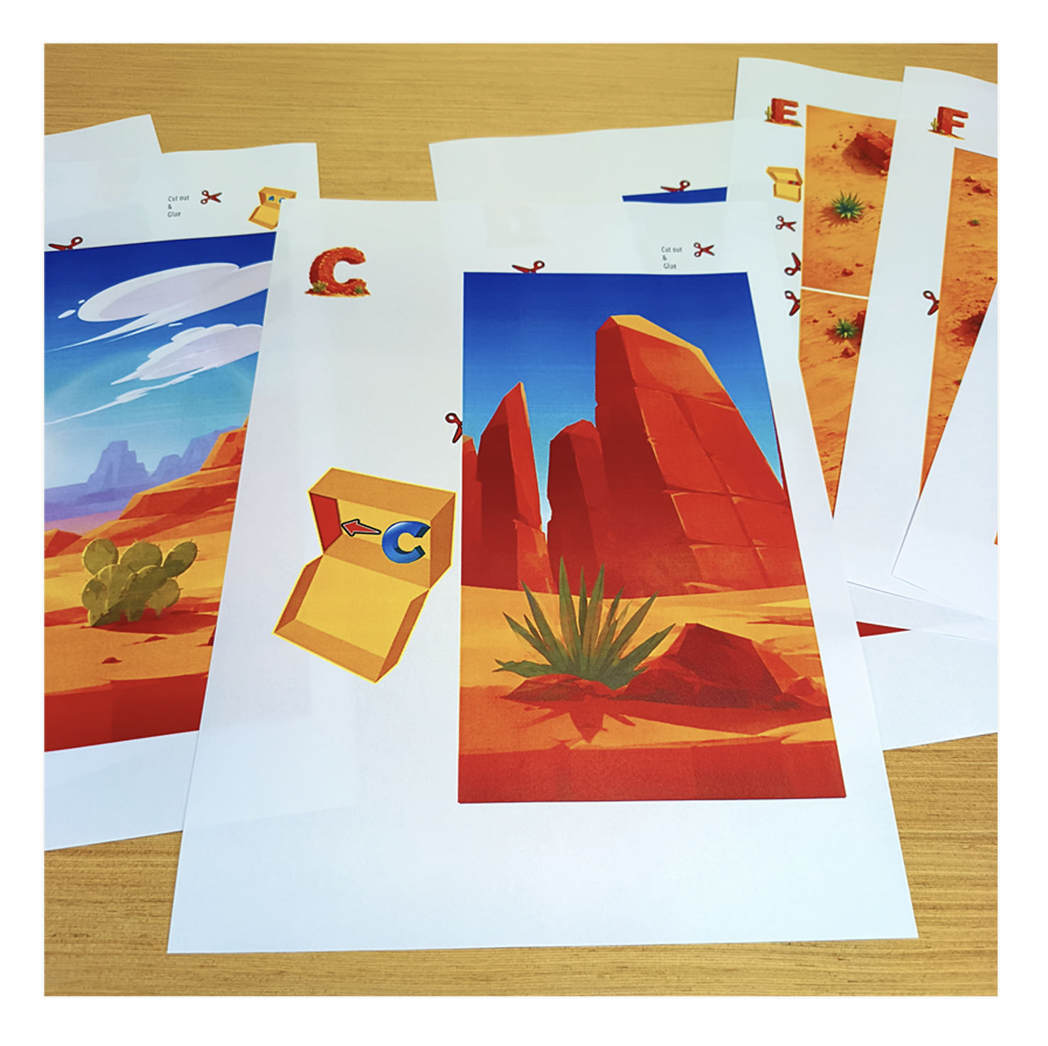 Close-up of printed Desert Habitat PDF craft pages showing illustrated pieces ready to cut out