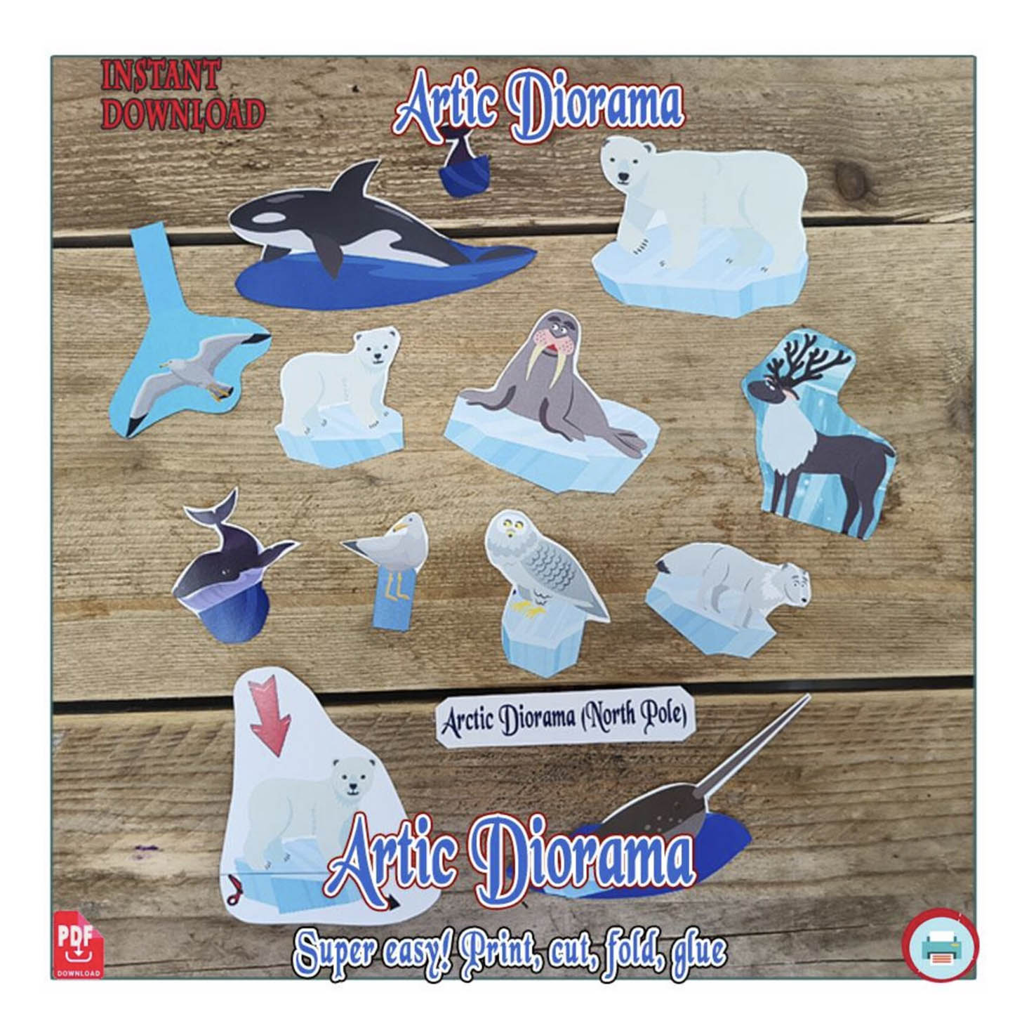 Cut-out Arctic paper animals laid on a table ready for a shoebox diorama