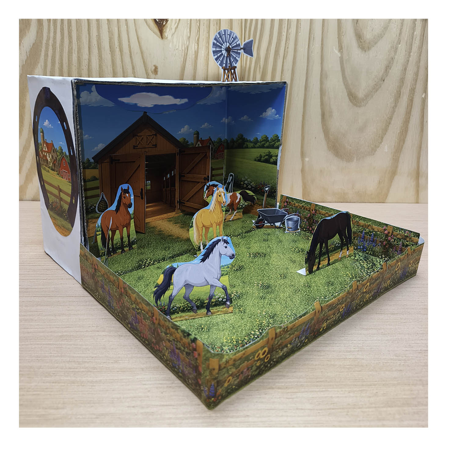 Side view of a completed horse paddock shoebox diorama with printable horses, stable, fences, flowers and windmill