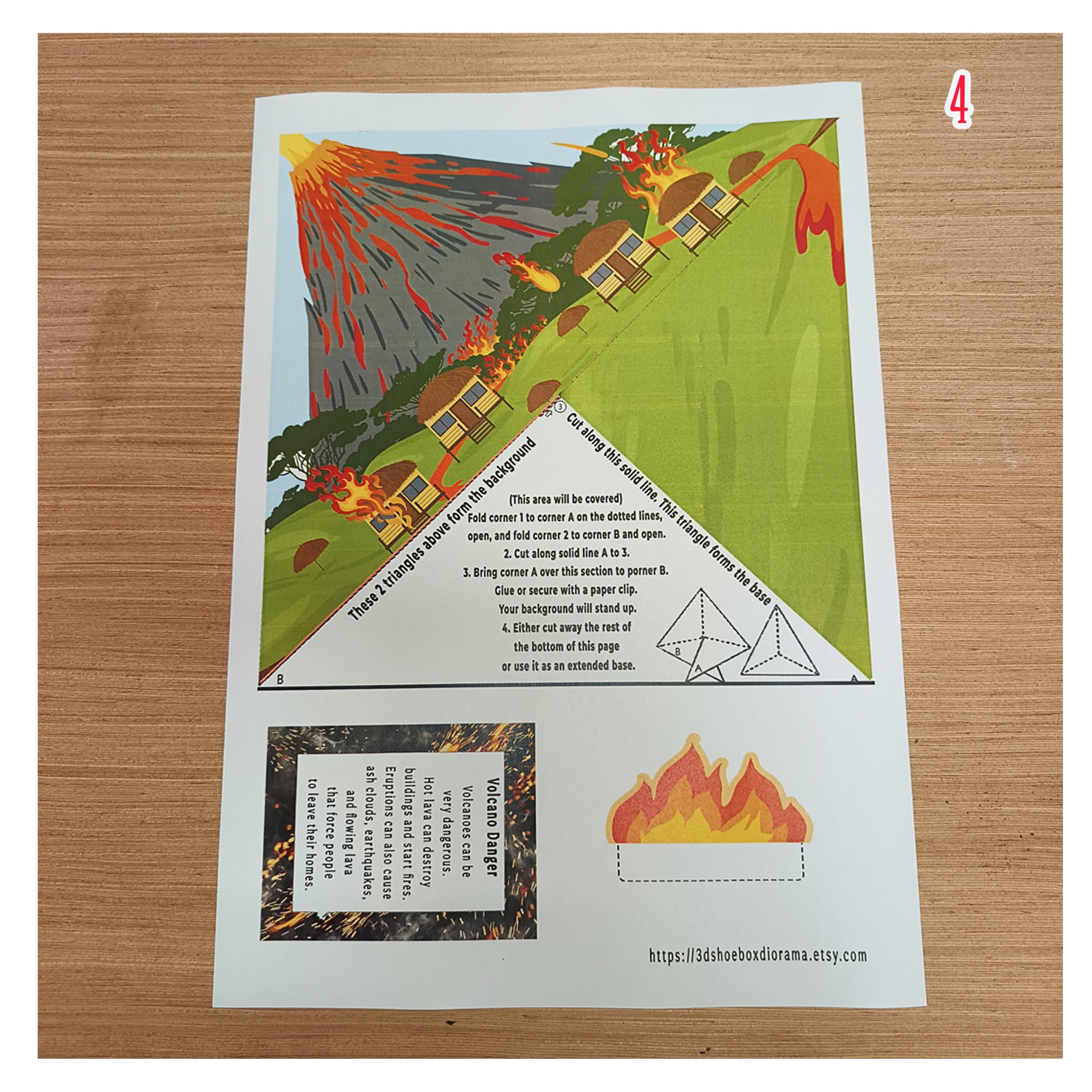 Printable volcano hazards scene with houses, lava, a fire cut-out and an educational card