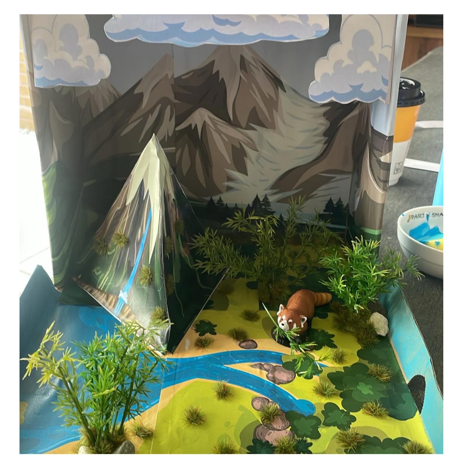 Student water cycle diorama with added greenery and a textured waterfall