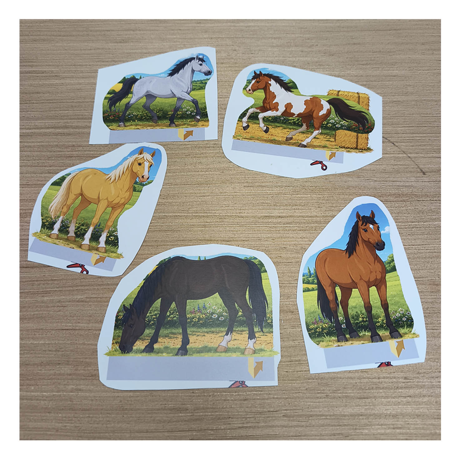 Five colorful printable paper horses cut out and ready to add to the horse stable and paddock diorama